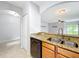 Kitchen showcasing granite countertops, stainless appliances, wood cabinetry, and a breakfast bar overlooking living area at 5431 Lochdale Dr, Orlando, FL 32818