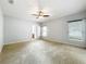 Large main bedroom with three windows allowing natural light and an en-suite bathroom at 5431 Lochdale Dr, Orlando, FL 32818