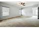 Spacious main bedroom with a ceiling fan, multiple windows, and ample space at 5431 Lochdale Dr, Orlando, FL 32818