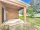 Covered patio featuring a neutral color scheme and views of the backyard at 5431 Lochdale Dr, Orlando, FL 32818