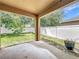 Covered patio with a view of the backyard and white vinyl fencing at 5431 Lochdale Dr, Orlando, FL 32818