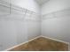 Empty walk-in closet with metal shelving and neutral carpet flooring at 5431 Lochdale Dr, Orlando, FL 32818