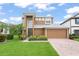 Beautiful two-story home featuring a well-maintained lawn, attached two-car garage and brick driveway at 600 Egret Place Dr, Winter Garden, FL 34787