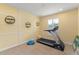 Brightly lit exercise room with neutral carpet and a treadmill, perfect for staying active at 600 Egret Place Dr, Winter Garden, FL 34787