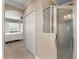 Hallway leading to bedroom featuring an ensuite bathroom with glass enclosed shower and a walk-in closet at 600 Egret Place Dr, Winter Garden, FL 34787