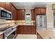 Gourmet kitchen features granite countertops, stainless steel appliances, and custom wood cabinetry at 600 Egret Place Dr, Winter Garden, FL 34787