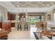 Open kitchen and living area featuring granite counters, stainless appliances, island seating, and access to an outdoor patio at 600 Egret Place Dr, Winter Garden, FL 34787