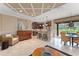 Open floor plan showcasing the kitchen with stainless appliances, bar seating, and views of the living area and outdoor space at 600 Egret Place Dr, Winter Garden, FL 34787