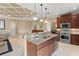 Well-equipped kitchen with stainless steel appliances, granite countertops, and views of the living area and dining space at 600 Egret Place Dr, Winter Garden, FL 34787