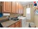 Practical laundry room featuring cabinets, countertop, sink, and a washing machine at 600 Egret Place Dr, Winter Garden, FL 34787
