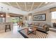 Comfortable living room with neutral tones, coffered ceiling, large windows, and sliding glass doors to a screened lanai at 600 Egret Place Dr, Winter Garden, FL 34787