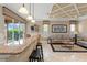 Living room with kitchen bar, large windows, and stylish furniture, offering a comfortable and open living space at 600 Egret Place Dr, Winter Garden, FL 34787