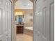 Ensuite bathroom with a walk-in shower, a soaking tub, a granite vanity, and private toilet at 600 Egret Place Dr, Winter Garden, FL 34787