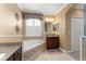 Bright bathroom featuring a soaking tub with granite accents, and plantation shutters for natural light at 600 Egret Place Dr, Winter Garden, FL 34787