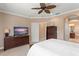 Spacious main bedroom featuring an ensuite bathroom, large dresser, and flat screen tv for relaxing at 600 Egret Place Dr, Winter Garden, FL 34787