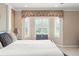 Comfortable bedroom showing a bench seat under a row of windows with white shutters, and decorative brown floral trim above at 600 Egret Place Dr, Winter Garden, FL 34787