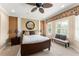 Comfortable main bedroom featuring a ceiling fan, bench seating, and plantation shutters for plenty of natural light at 600 Egret Place Dr, Winter Garden, FL 34787