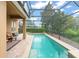 Inviting swimming pool with a screened enclosure, providing a private and refreshing oasis with ample seating area at 600 Egret Place Dr, Winter Garden, FL 34787