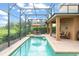 Captivating screened pool area with pristine pool, ample seating, and lush landscaping, ideal for outdoor living and entertaining at 600 Egret Place Dr, Winter Garden, FL 34787