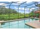 Serene screened pool area with lush greenery, creating a tranquil and private retreat for relaxation and enjoyment at 600 Egret Place Dr, Winter Garden, FL 34787