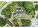Aerial view of a home with a screened in pool surrounded by mature trees and lush landscaping at 8735 Rancho Ct, Orlando, FL 32836