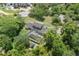 Aerial view of a home with a screened in pool surrounded by mature trees and lush landscaping at 8735 Rancho Ct, Orlando, FL 32836