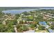 Aerial view of property showcasing the home's location near a lake at 8735 Rancho Ct, Orlando, FL 32836