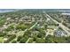 Wide angle aerial view of a residential neighborhood with established trees, roads, and sidewalks at 8735 Rancho Ct, Orlando, FL 32836