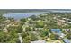 Expansive aerial view showcasing the neighborhood with lush greenery and lake views at 8735 Rancho Ct, Orlando, FL 32836