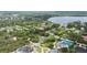 Beautiful aerial view of the community with lush landscaping, tennis court, and a lake at 8735 Rancho Ct, Orlando, FL 32836