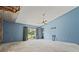 Spacious bedroom with large sliding glass door and ceiling fan at 8735 Rancho Ct, Orlando, FL 32836