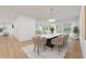 Dining area with seating for eight, complemented by an open floor plan and modern finishes at 8735 Rancho Ct, Orlando, FL 32836