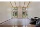 Empty room featuring large windows and hardwood floors at 8735 Rancho Ct, Orlando, FL 32836