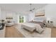 Beautifully staged main bedroom with a seating area and sliding door to backyard at 8735 Rancho Ct, Orlando, FL 32836