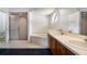 Bathroom with dual sinks, a soaking tub, and a separate shower at 9108 N Bay Boulevard, Orlando, FL 32819