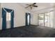 Bedroom with a ceiling fan and sliding glass doors leading to the pool area at 9108 N Bay Boulevard, Orlando, FL 32819