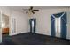 Spacious bedroom featuring a ceiling fan and a doorway leading to the bathroom at 9108 N Bay Boulevard, Orlando, FL 32819