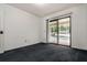 Bedroom with plush carpeting and sliding glass doors leading to an enclosed pool area at 9108 N Bay Boulevard, Orlando, FL 32819