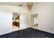 Open dining room with chandelier, neutral walls, dark blue carpet, white trim and doorways to other rooms at 9108 N Bay Boulevard, Orlando, FL 32819