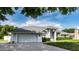 This single-story home features a spacious garage, a well-maintained lawn, and a charming exterior at 9108 N Bay Boulevard, Orlando, FL 32819