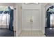 Bright foyer with tile flooring, double front doors, and views of rooms with elegant window treatments at 9108 N Bay Boulevard, Orlando, FL 32819
