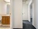 Hallway with plush blue carpet, leading to a bathroom on the left and another room straight ahead at 9108 N Bay Boulevard, Orlando, FL 32819