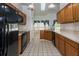 Spacious kitchen with black appliances, a skylight, and white tiled floors at 9108 N Bay Boulevard, Orlando, FL 32819