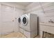 Laundry room featuring a washer and dryer and wire shelving at 9108 N Bay Boulevard, Orlando, FL 32819