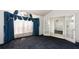 This living room features neutral walls, dark blue carpeting, large windows and white trim at 9108 N Bay Boulevard, Orlando, FL 32819