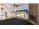 Bright living room features a brick fireplace and access to the outdoor pool area at 9108 N Bay Boulevard, Orlando, FL 32819