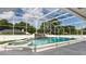 Enclosed pool with rock waterfall, spa, and surrounding landscaping at 9108 N Bay Boulevard, Orlando, FL 32819