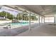 Screened-in pool area with tiled deck and waterfall feature at 9108 N Bay Boulevard, Orlando, FL 32819