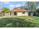 View of the home's exterior showcasing the backyard, patio, and privacy fence at 1007 Glendale St, Orlando, FL 32807