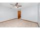 Bedroom features neutral tile floors, a ceiling fan, and wood base trim around the base of the wall at 1007 Glendale St, Orlando, FL 32807